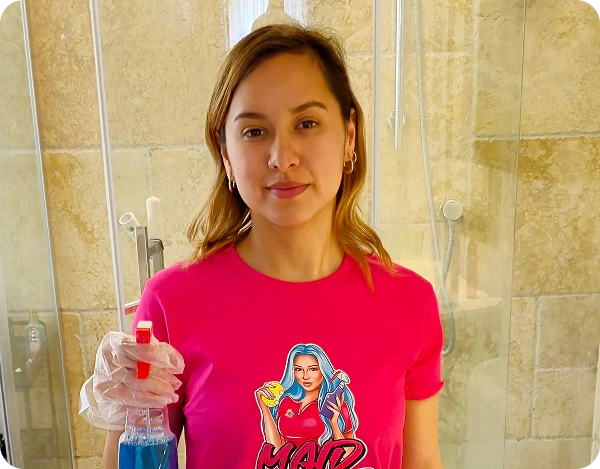 Cleaner cleaning windows during a residential cleaning service for houses and condos.