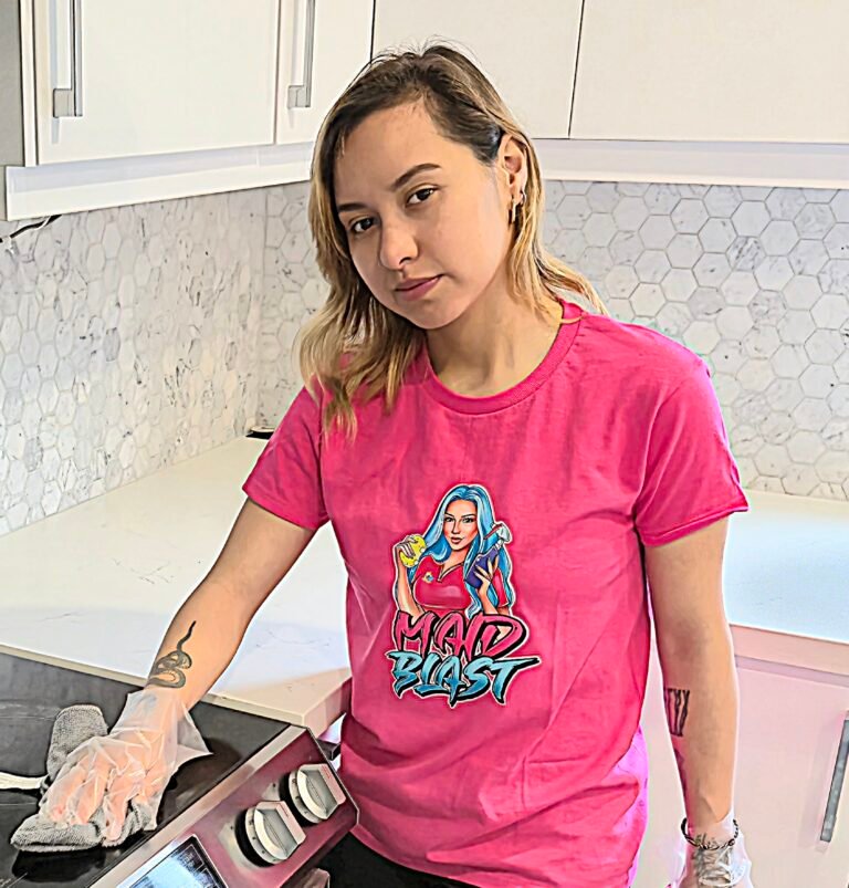 cleaner cleaning a stovetop during a condo cleaning service.
