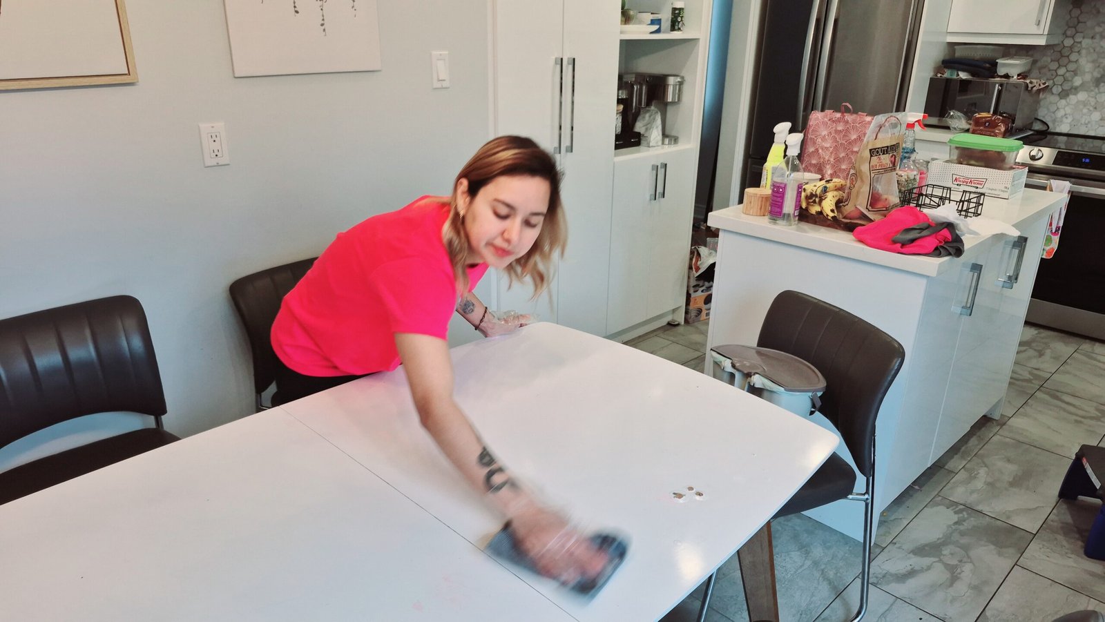 Cleaner cleaning the kitchen table during a house cleaning service.